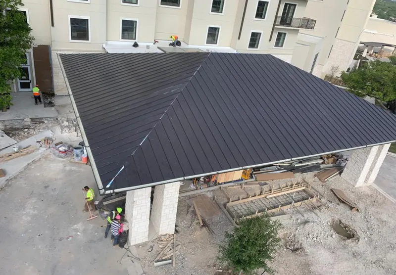 Metal roofing installation team working on a commercial building in Eagle
